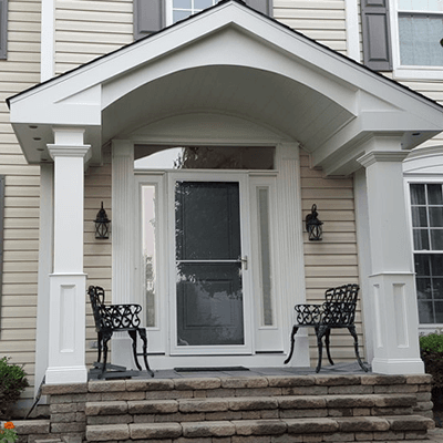 NJ Discount Vinyl Siding crew installing siding on large white home